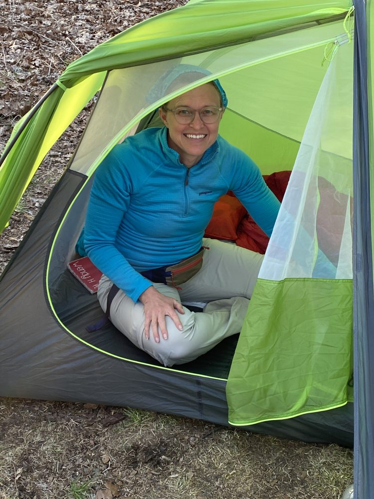 woman inside a green tent